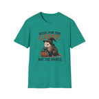 A teal green short-sleeve crewneck t-shirt featuring a Halloween graphic of an opossum wearing a witch hat and holding a pumpkin candy basket, with the text 'HERE FOR THE CANDY. NOT THE PEOPLE.