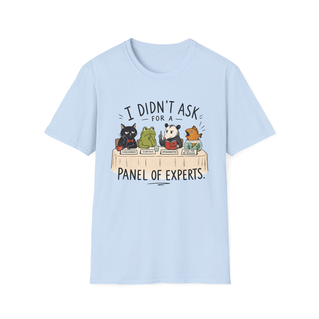 A light blue short-sleeve crewneck t-shirt featuring a cartoon graphic of four animals (a cat, frog, panda, and fox) sitting on books and reading, with the text 'I DIDN'T ASK FOR A PANEL OF EXPERTS.' printed above and below.