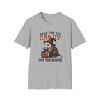 A light heather gray short-sleeve crewneck t-shirt featuring a Halloween graphic of an opossum wearing a witch hat and holding a jack-o'-lantern with the text 'HERE FOR THE CANDY. NOT THE PEOPLE.