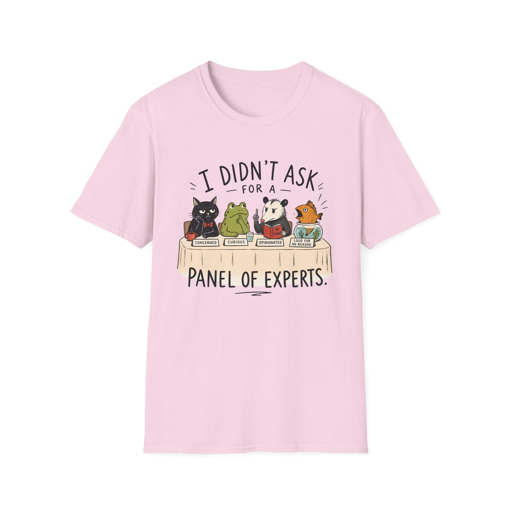 A light pink short-sleeve crewneck t-shirt featuring a cartoon graphic of five animals (a cat, frog, panda, and two birds) sitting on books, with the text 'I DIDN'T ASK FOR A PANEL OF EXPERTS.' printed above and below.