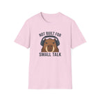 Light pink t-shirt with image of a capybara wearing headphones and text 'not built for small talk'