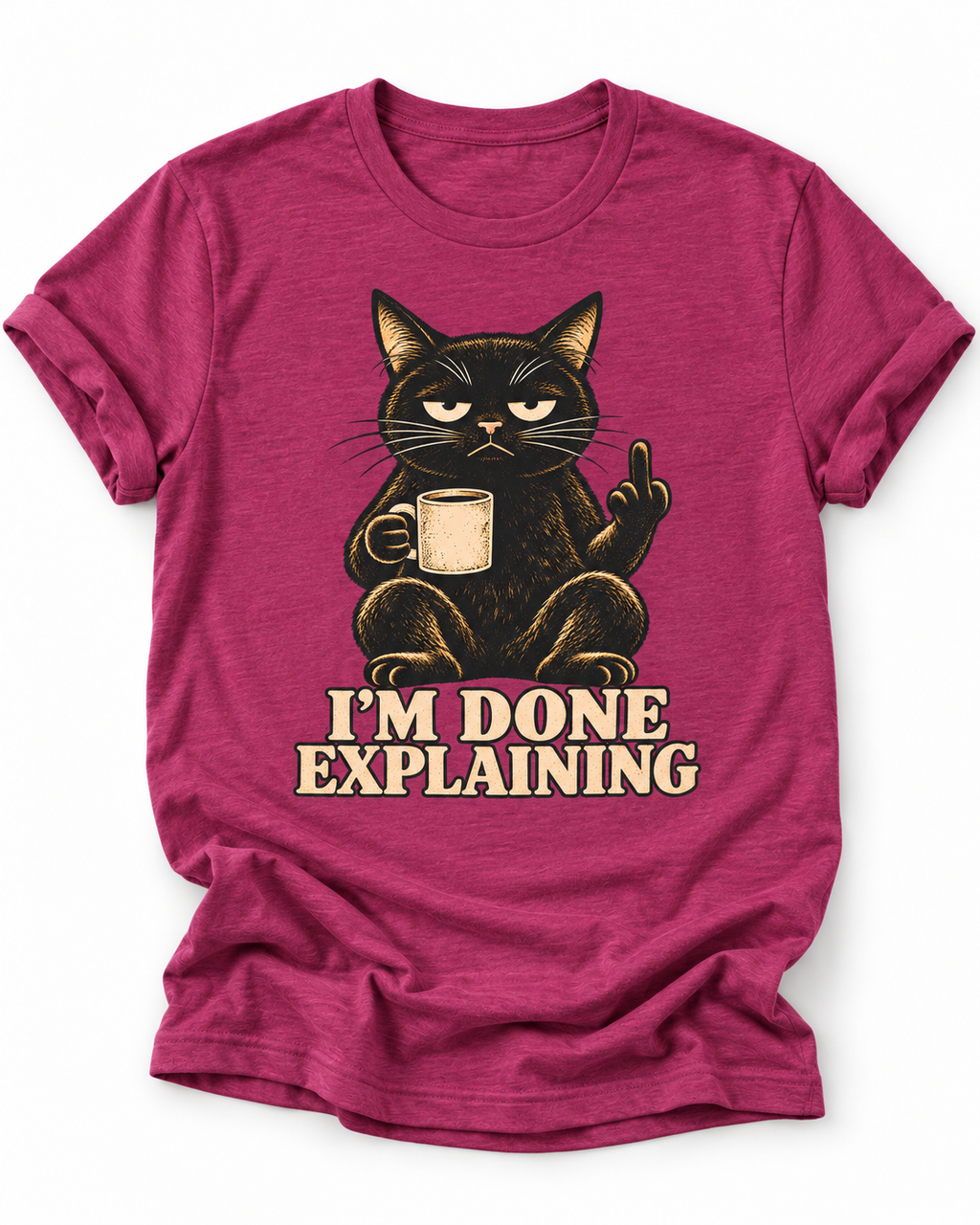 Pink t-shirt of a Black cat holding a coffee mug and raising its middle finger above the words “I’m Done Explaining” in bold cream vintage 
