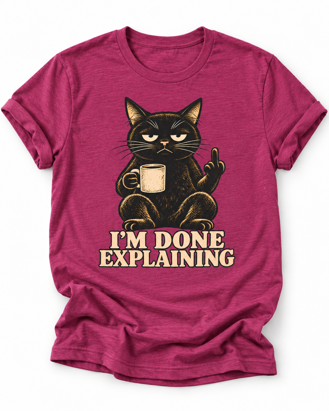 Pink t-shirt of a Black cat holding a coffee mug and raising its middle finger above the words “I’m Done Explaining” in bold cream vintage 