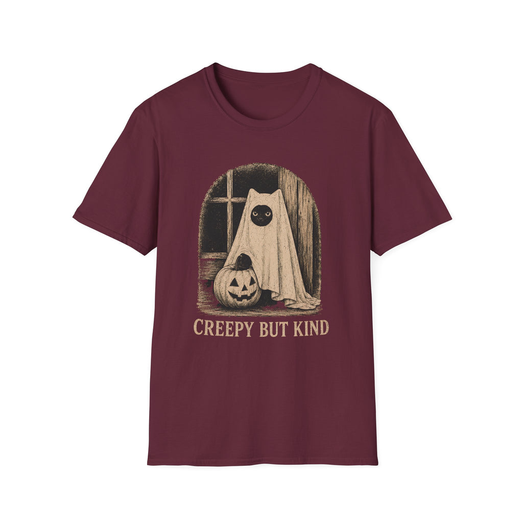 A maroon short-sleeve crewneck t-shirt featuring a vintage-style Halloween graphic of a ghostly figure with a large black eye next to a carved pumpkin, with the text 'CREEPY BUT KIND' printed below.