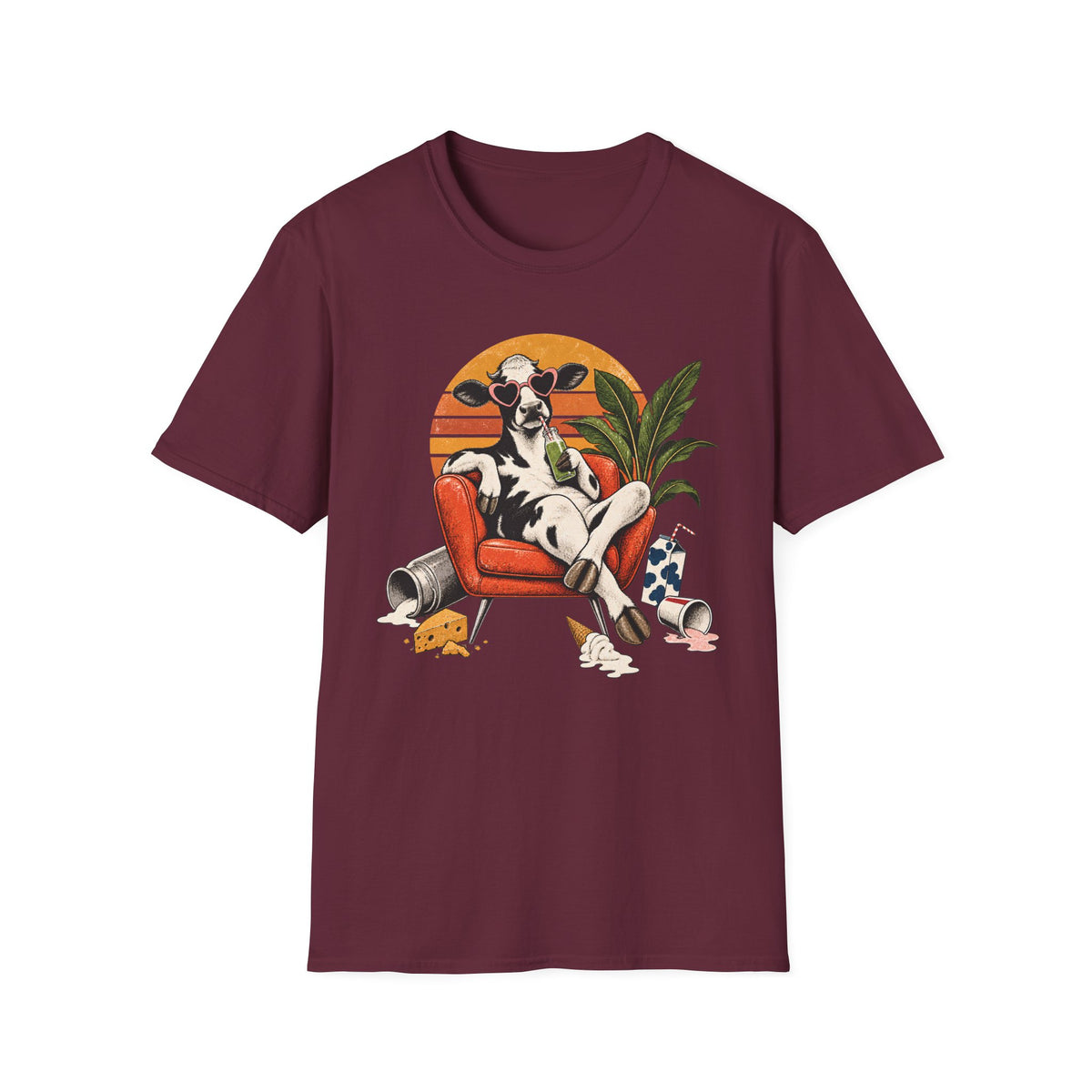 A maroon short-sleeve crewneck t-shirt featuring a colorful graphic print of a cow lounging in an orange armchair against a sunset background.
