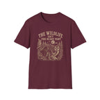 Maroon t-shirt with nature graphic of animals and halloween characters walking up a path and text 'the wildlife isn;t the scary part