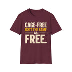 A maroon short-sleeve crewneck t-shirt with a graphic text print reading 'CAGE-FREE ISN'T THE SAME AS FREE.' in cream and mustard yellow lettering, displayed on a solid white background.