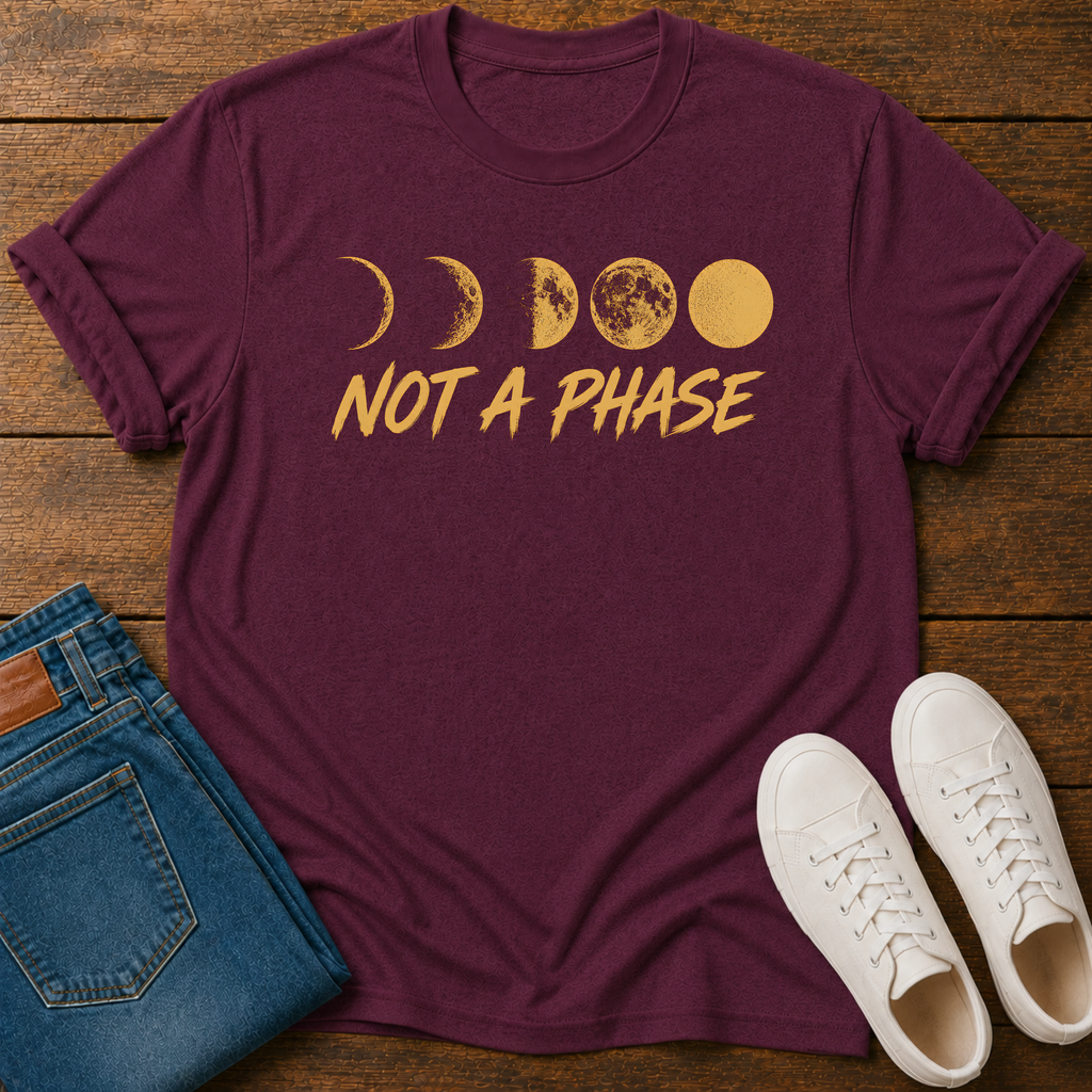 Not A Phase graphic t-shirt design with gold moon phases and bold lettering on a dark background