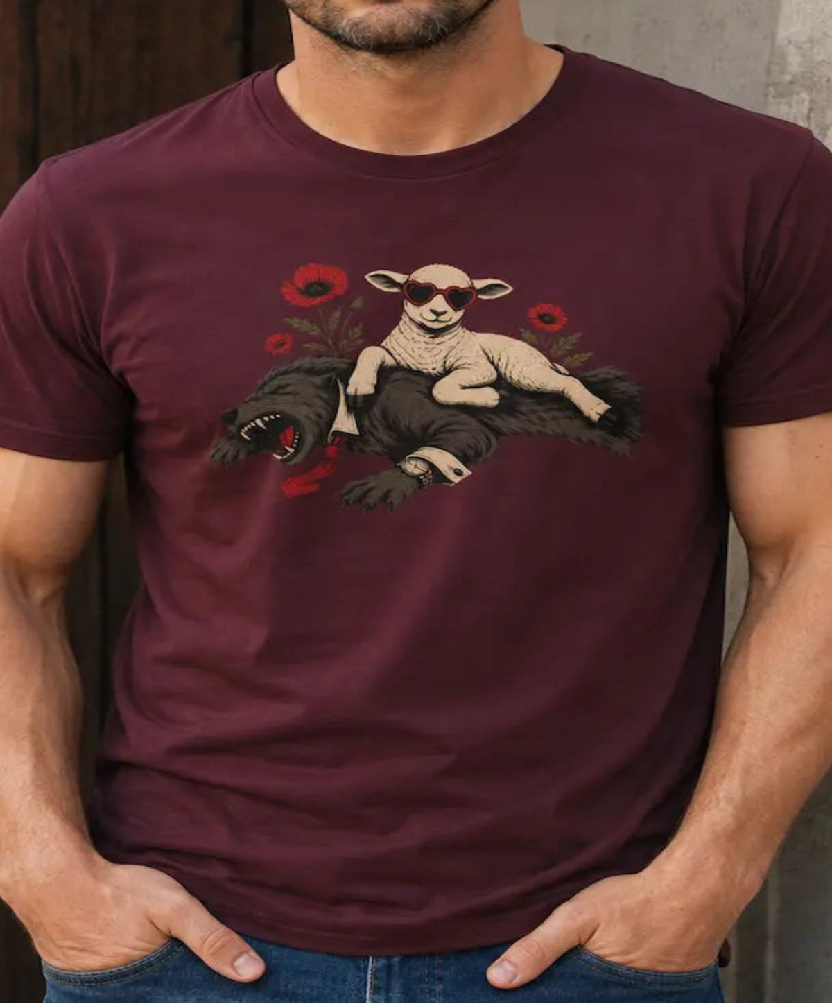 Man wearing a maroon vegan tee with image of a sheep on top of a wolf surrounded by flowers