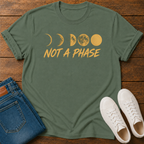 Not A Phase graphic t-shirt design with gold moon phases and bold lettering on a dark background