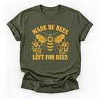 Military green short-sleeve t-shirt with a yellow graphic print featuring a bee, honeycomb, flowers, and the text 'MADE BY BEES LEFT FOR BEES' on a white background.