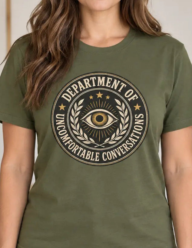Woman wearing a military green t-shirt with a graphic and text 'department of uncomfortable conversations'