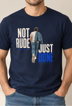 A man wearing a navy blue graphic t-shirt with the text 'NOT RUDE JUST DONE' and an illustration of a person walking away, paired with blue jeans, standing against a neutral beige background.