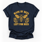 A navy blue short-sleeve t-shirt with a yellow graphic print featuring a bee, honeycomb, flowers, and the text 'MADE BY BEES LEFT FOR BEES' on a white background.