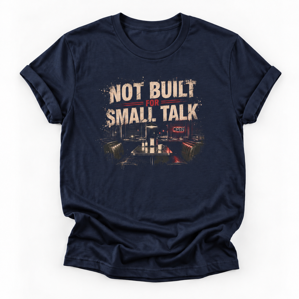 A navy blue short-sleeve t-shirt with a distressed graphic on the chest that reads 'NOT BUILT FOR SMALL TALK' above a dark industrial interior scene, shown on a plain white background.