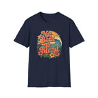A navy blue short-sleeve crewneck t-shirt featuring a retro-style circular graphic on the chest with the text 'Not Born To Blend' in orange, surrounded by a wave, palm tree, and hibiscus flowers.