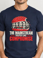 a man wearing A navy blue short-sleeve t-shirt with a graphic of a burger filled with faces wearing braces, above the text 'THE MAINSTREAM TASTES LIKE COMPROMISE' in white and red.