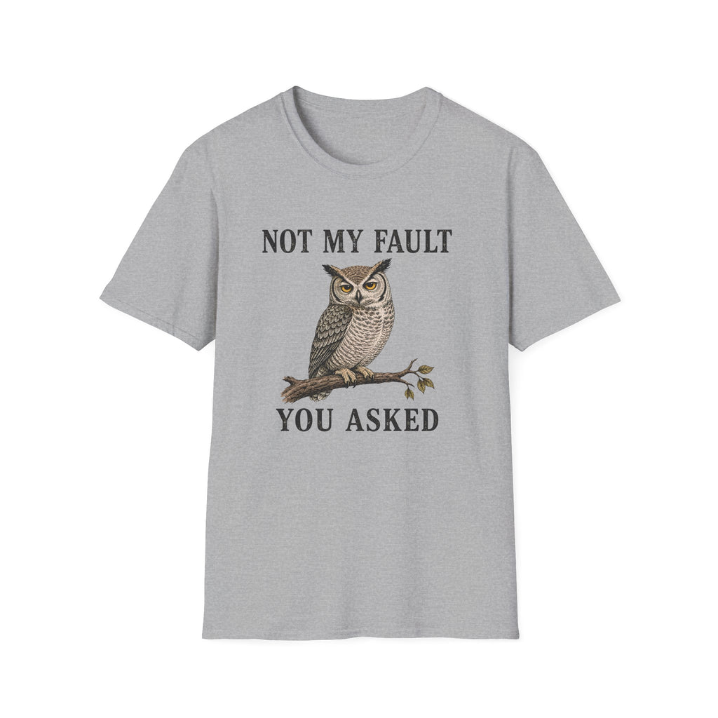 A Grey graphic t-shirt laid flat on a wooden surface, styled with blue jeans, white sneakers. The t-shirt features a graphic of a owl perched on a branch with the text 'NOT MY FAULT YOU ASKED' in black.