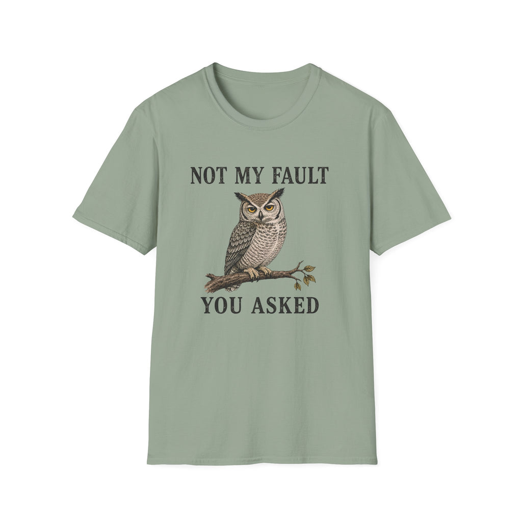 A sage green graphic t-shirt features a graphic of a owl perched on a branch with the text 'NOT MY FAULT YOU ASKED' in black.