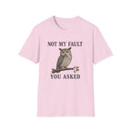 A light pink graphic t-shirt features a graphic of a owl perched on a branch with the text 'NOT MY FAULT YOU ASKED' in black.