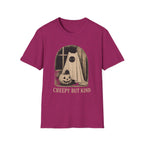 A heather magenta short-sleeve t-shirt with a vintage-style Halloween graphic of a ghostly figure in a sheet next to a jack-o'-lantern, with the text 'CREEPY BUT KIND' printed below.