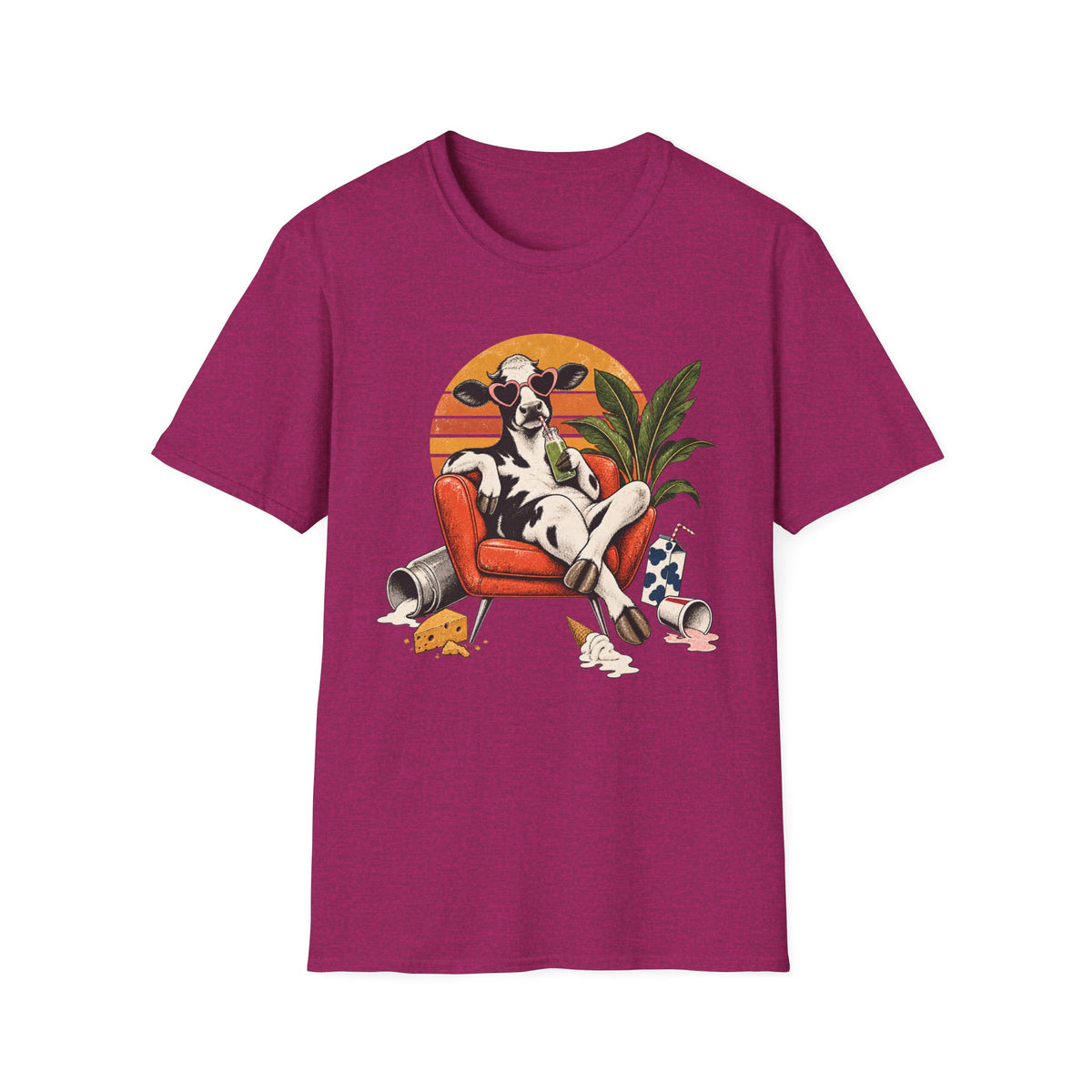 Pink short-sleeve crewneck t-shirt featuring a colorful graphic print of a cow lounging in an orange armchair against a sunset background.