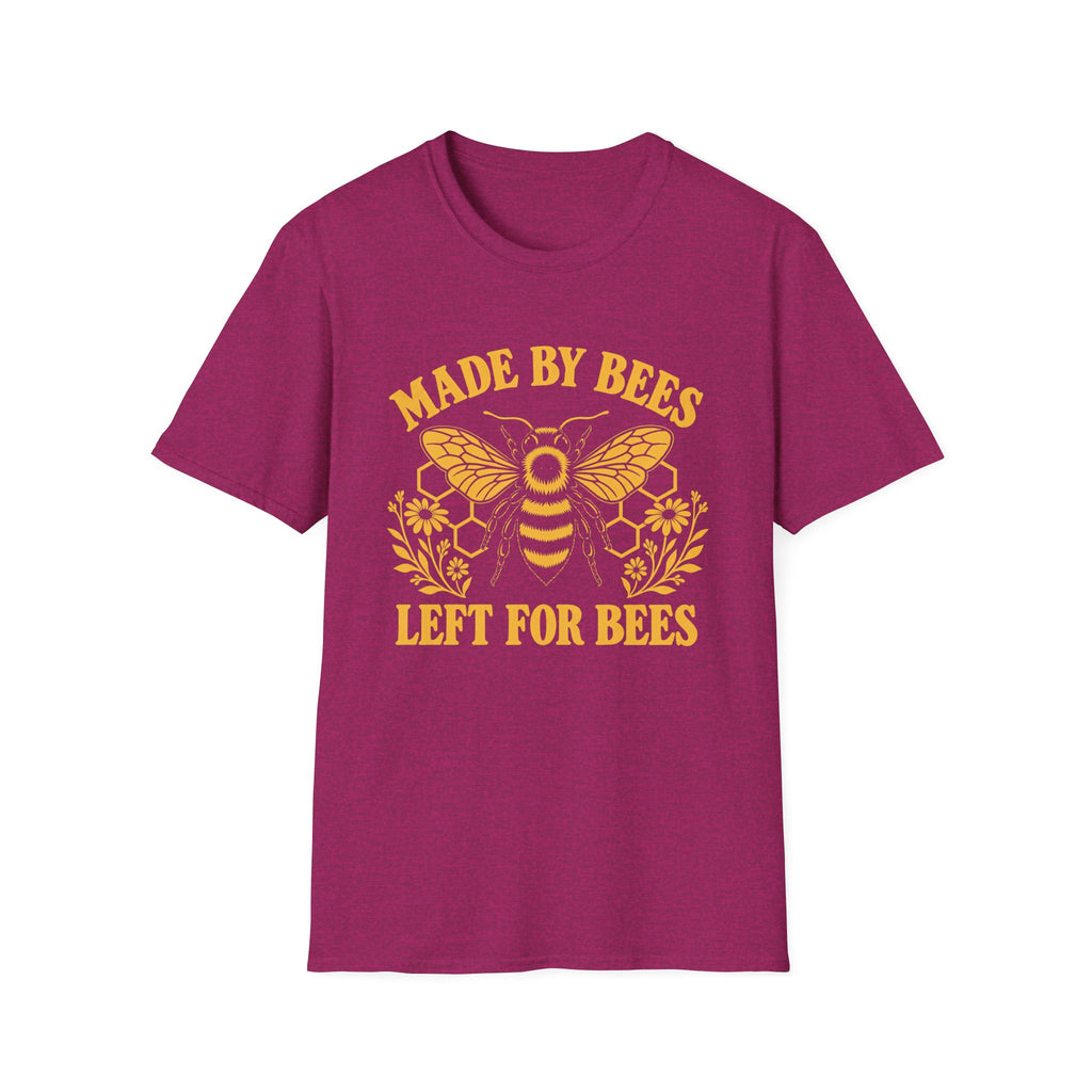A heather magenta short-sleeve crewneck t-shirt featuring a yellow graphic of a bumblebee with honeycomb patterns and the text 'MADE BY BEES LEFT FOR BEES' printed on the front.