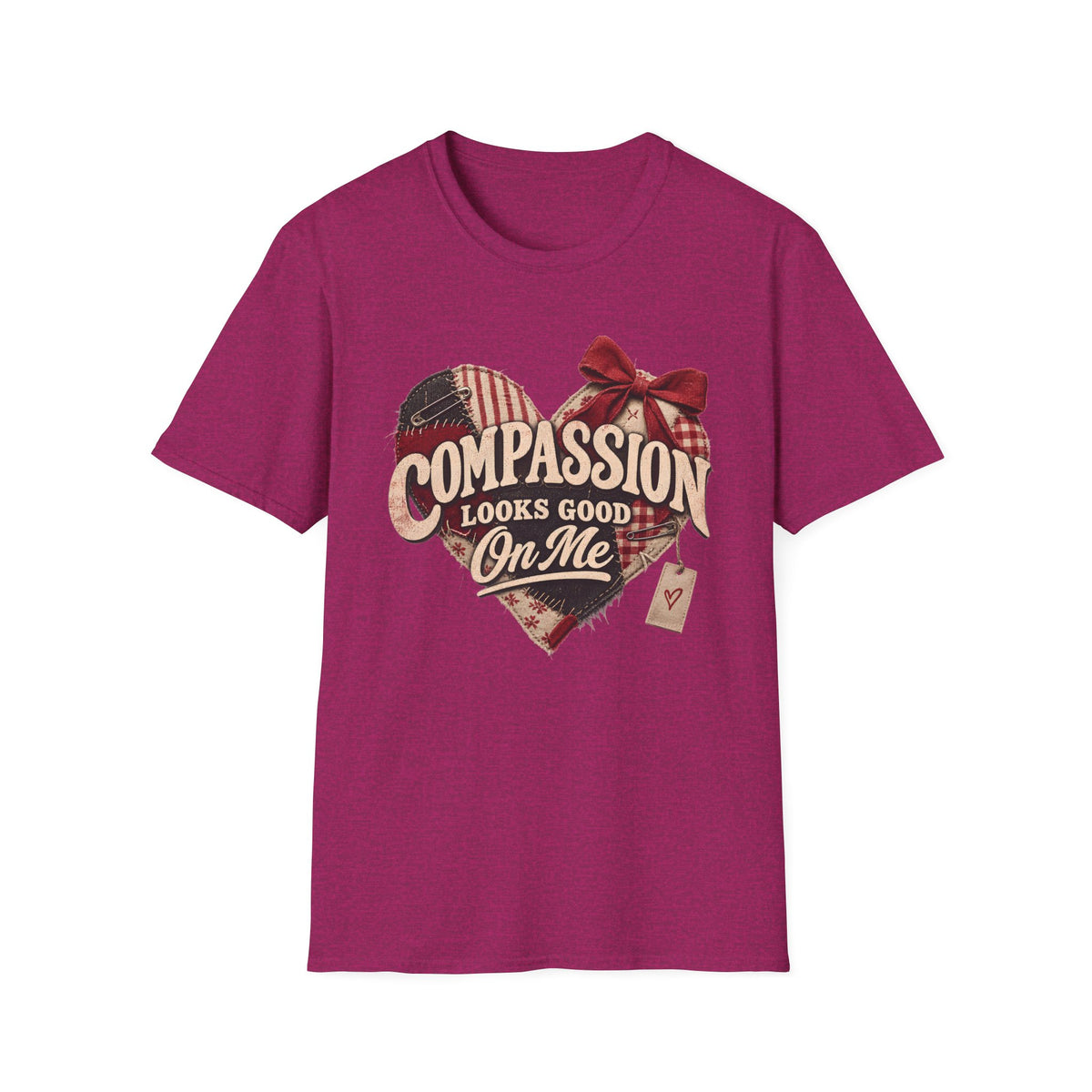 A heather magenta short-sleeve t-shirt with a graphic on the chest featuring a heart made of American flag and plaid patterns, a red bow, and the text 'COMPASSION LOOKS GOOD ON ME'.