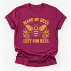 Pink yellow graphic print featuring a bee, honeycomb, flowers, and the text 'MADE BY BEES LEFT FOR BEES' on a white background.