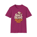 A heather magenta short-sleeve t-shirt with a retro-style graphic on the chest that reads 'SOFT HEART HARD NO' in cream and orange lettering, decorated with a small daisy and bee illustration, shown on a plain white background.