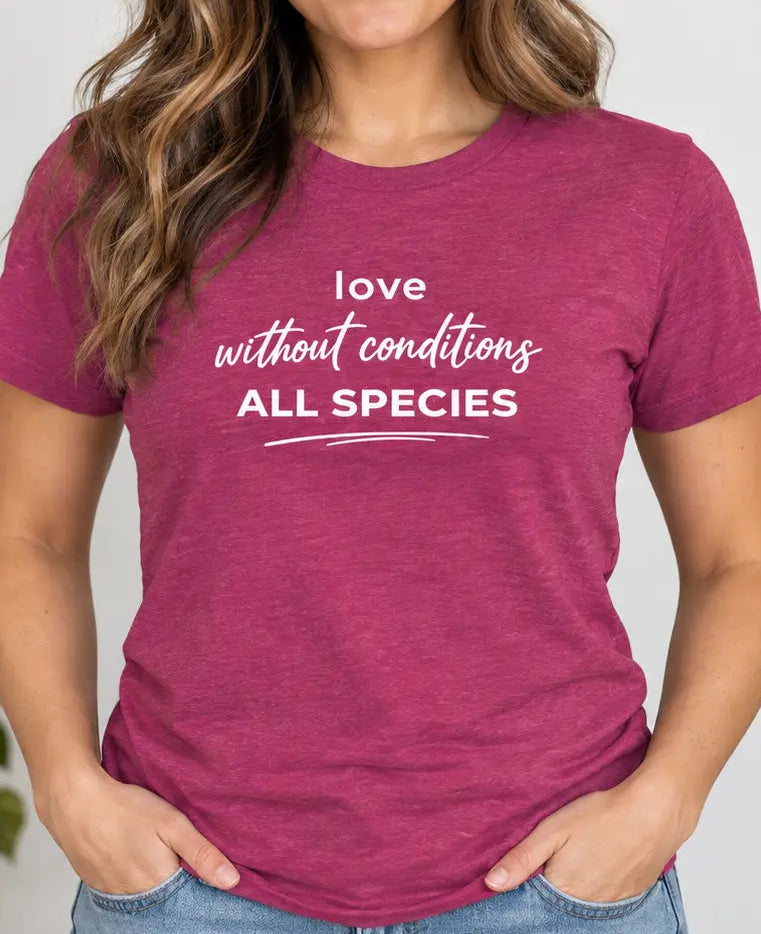 Woman wearing a pink t-shirt with text 'love without conditions all species'