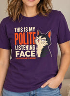 A woman wearing a purple graphic t-shirt with a cat illustration and the text 'THIS IS MY POLITE LISTENING FACE'.