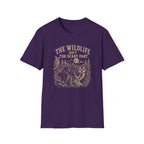 Purple t-shirt with nature graphic of animals and halloween characters walking up a path and text 'the wildlife isn;t the scary part