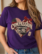 woman wearing a purple t-shirt with the message compassion looks good on me in a heart.