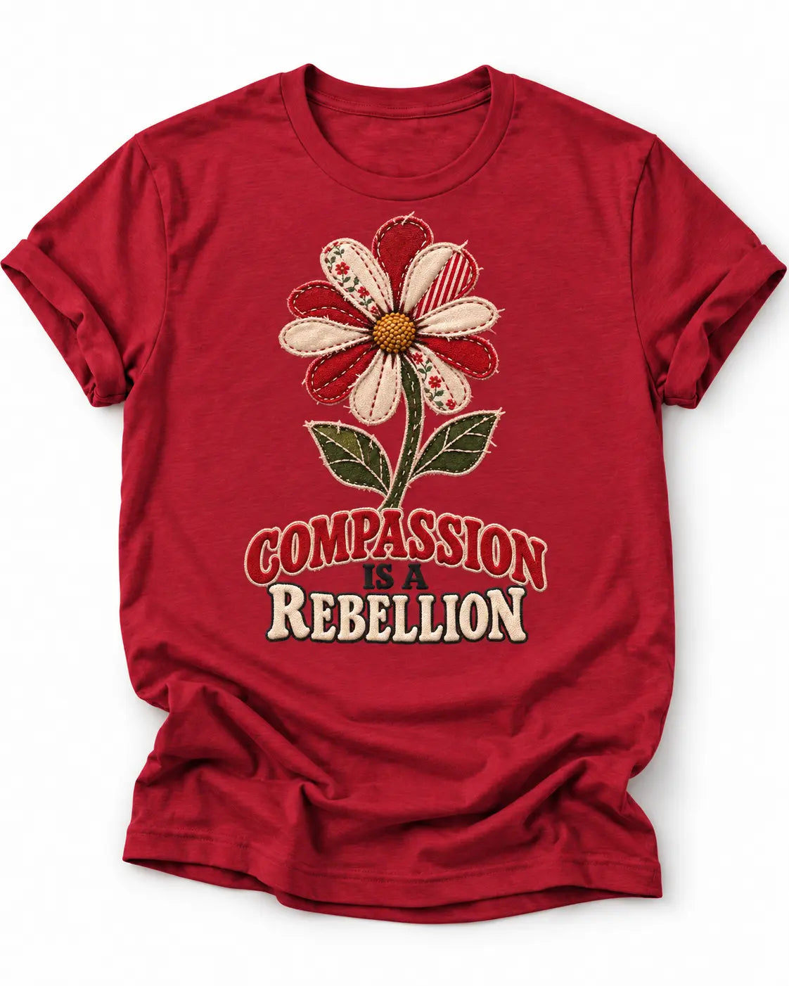 Red t-shirt with a patchwork style flower and text 'compassion is a rebellion'