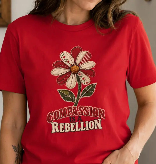 woman wearing a red t-shirt with text 'compassion is a rebellion