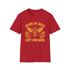 A red short-sleeve crewneck t-shirt with a yellow graphic print featuring a bee, honeycomb, flowers, and the text 'MADE BY BEES LEFT FOR BEES' on a light gray background.