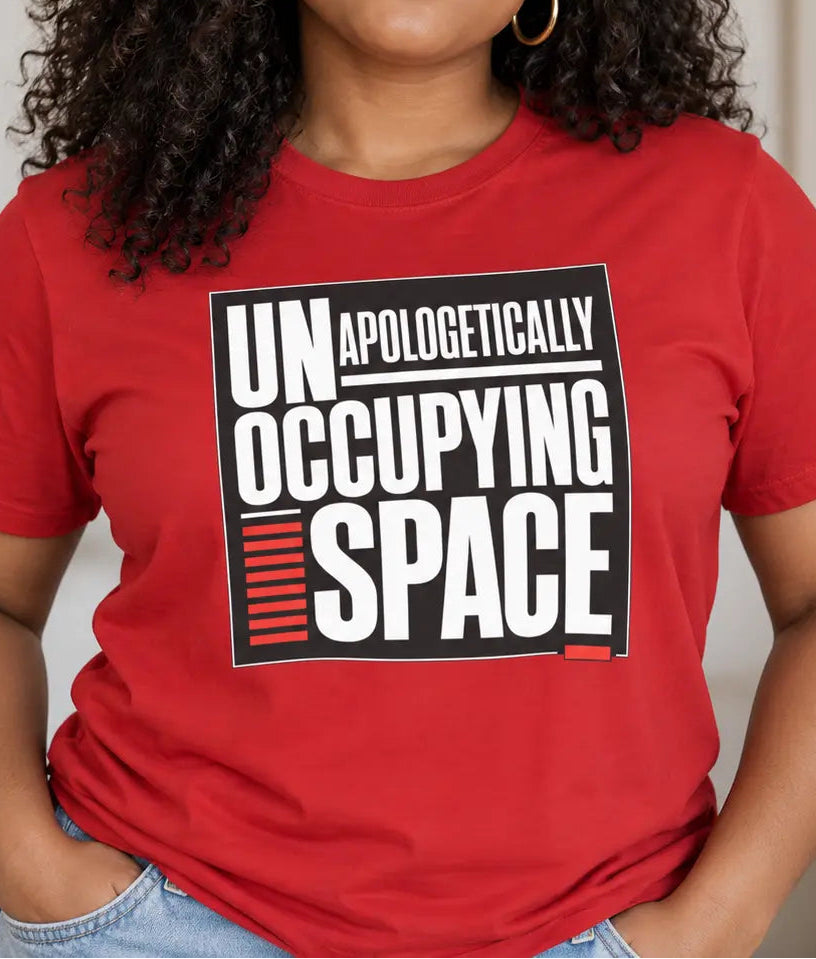 Woman wearing a red t-shirt with the text 'unapologetically occupying space'