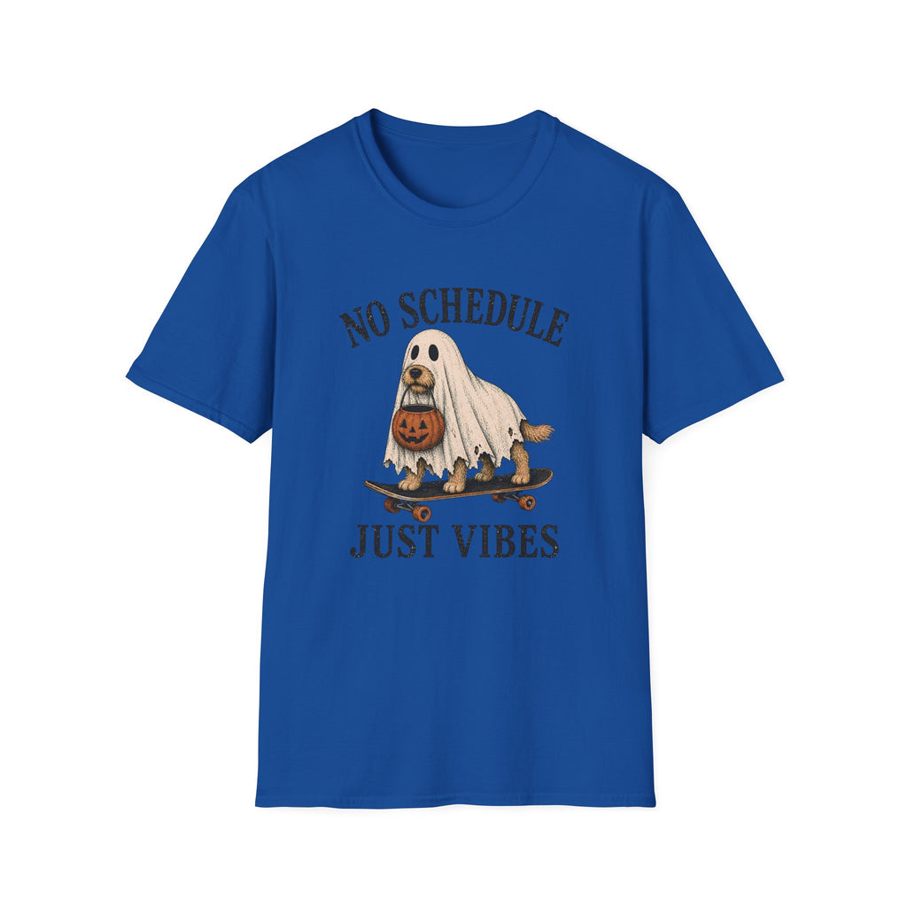 A royal blue short-sleeve crewneck t-shirt featuring a Halloween graphic of a ghost riding a skateboard with a pumpkin, with the text 'NO SCHEDULE JUST VIBES' printed in a distressed dark font.