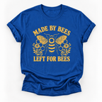A royal blue short-sleeve t-shirt with a yellow graphic print featuring a bee, honeycomb, flowers, and the text 'MADE BY BEES LEFT FOR BEES' on a white background.