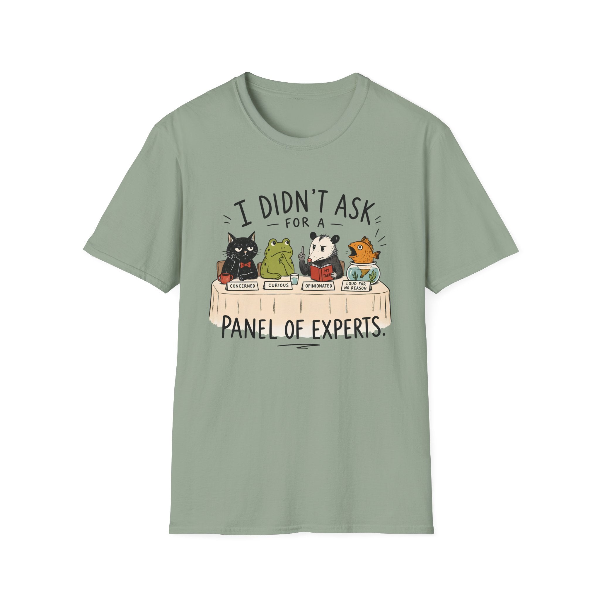 A sage green short-sleeve crewneck t-shirt featuring a cartoon graphic of four animals (a cat, frog, panda, and turtle) sitting at a table with the text 'I DIDN'T ASK FOR A PANEL OF EXPERTS.'.