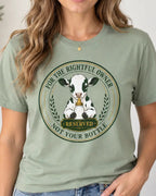 woman wearing a sage green t-shirt with graphic of a cow and text 'for the rightful owner not your bottle'