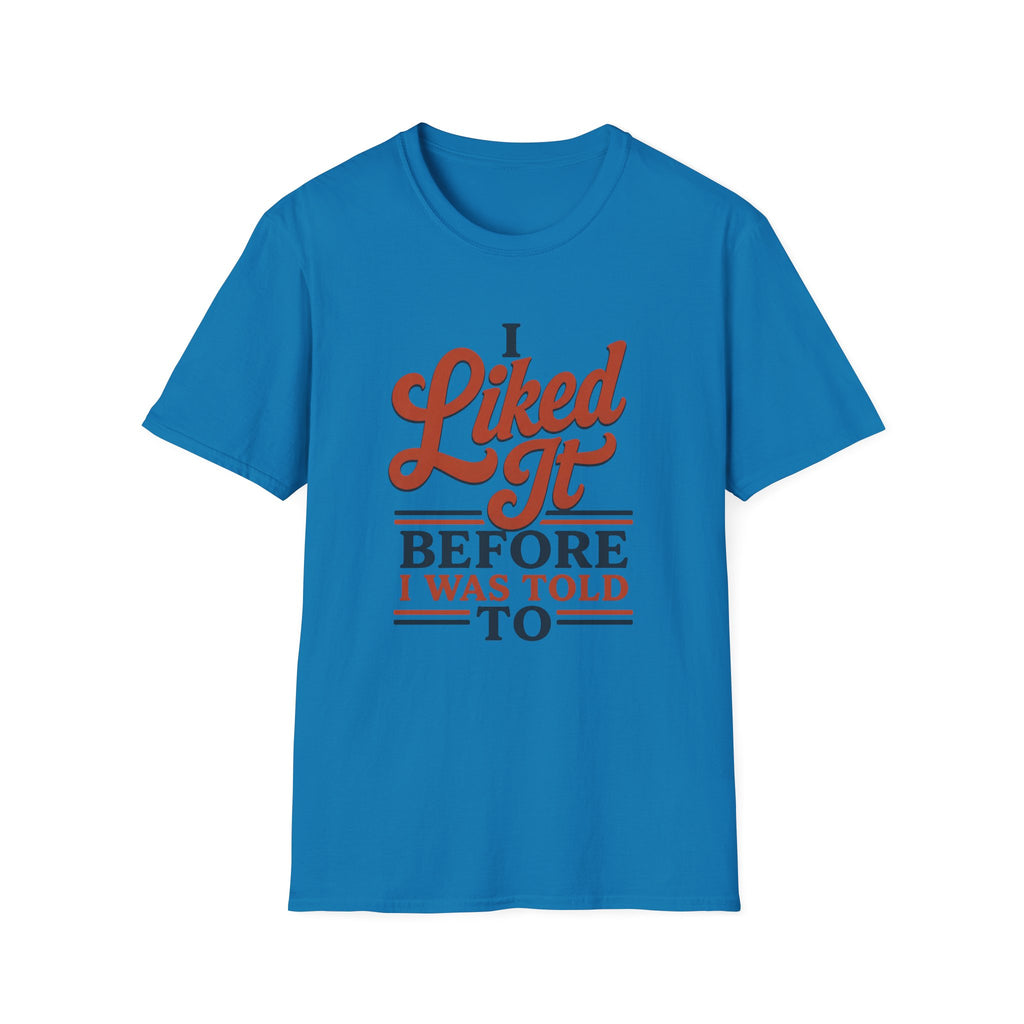 A bright blue short-sleeve crewneck t-shirt with a retro-style graphic on the chest that reads 'I Liked It BEFORE I WAS TOLD TO' in orange and navy blue lettering, displayed on a solid white background.