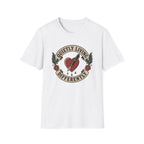 A white short-sleeve crewneck t-shirt featuring a vintage-style tattoo graphic on the chest. The graphic depicts a red heart pierced by a needle, with banners reading 'QUIETLY LIVING' and 'DIFFERENTLY' flanked by green leaves and red roses.
