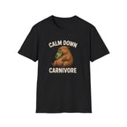 A black vegan short-sleeve crewneck t-shirt featuring a cartoon graphic of a brown groundhog holding green lettuce, with the text 'CALM DOWN CARNIVORE' printed in beige above and below the illustration.