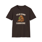 A vegan dark brown short-sleeve t-shirt with a graphic of a brown groundhog holding green lettuce, with the text 'CALM DOWN CARNIVORE' in beige, displayed on a solid white background.
