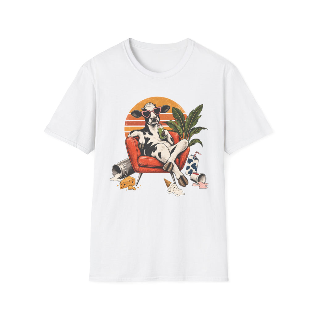 A white short-sleeve crewneck t-shirt featuring a colorful graphic print of a cow lounging in an orange armchair against a sunset background.