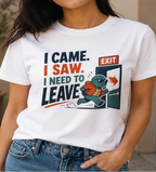 Woman wearing a white graphic tee with text 'i came i saw i need to leave'