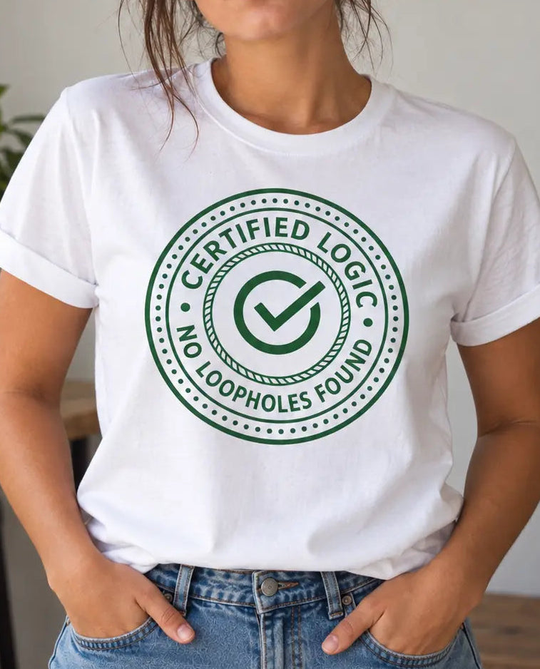 A woman wearing a white crewneck t-shirt with a green circular graphic that reads 'CERTIFIED LOGIC NO LOOPHOLE FOUND' with a checkmark, standing in a brightly lit indoor setting with plants in the background.
