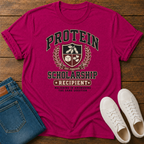 hot pink  t-shirt with Vintage collegiate crest design reading “Protein Scholarship Recipient” with soybean, tofu, and bean illustrations and the words “Majoring in Answering the Same Question.”